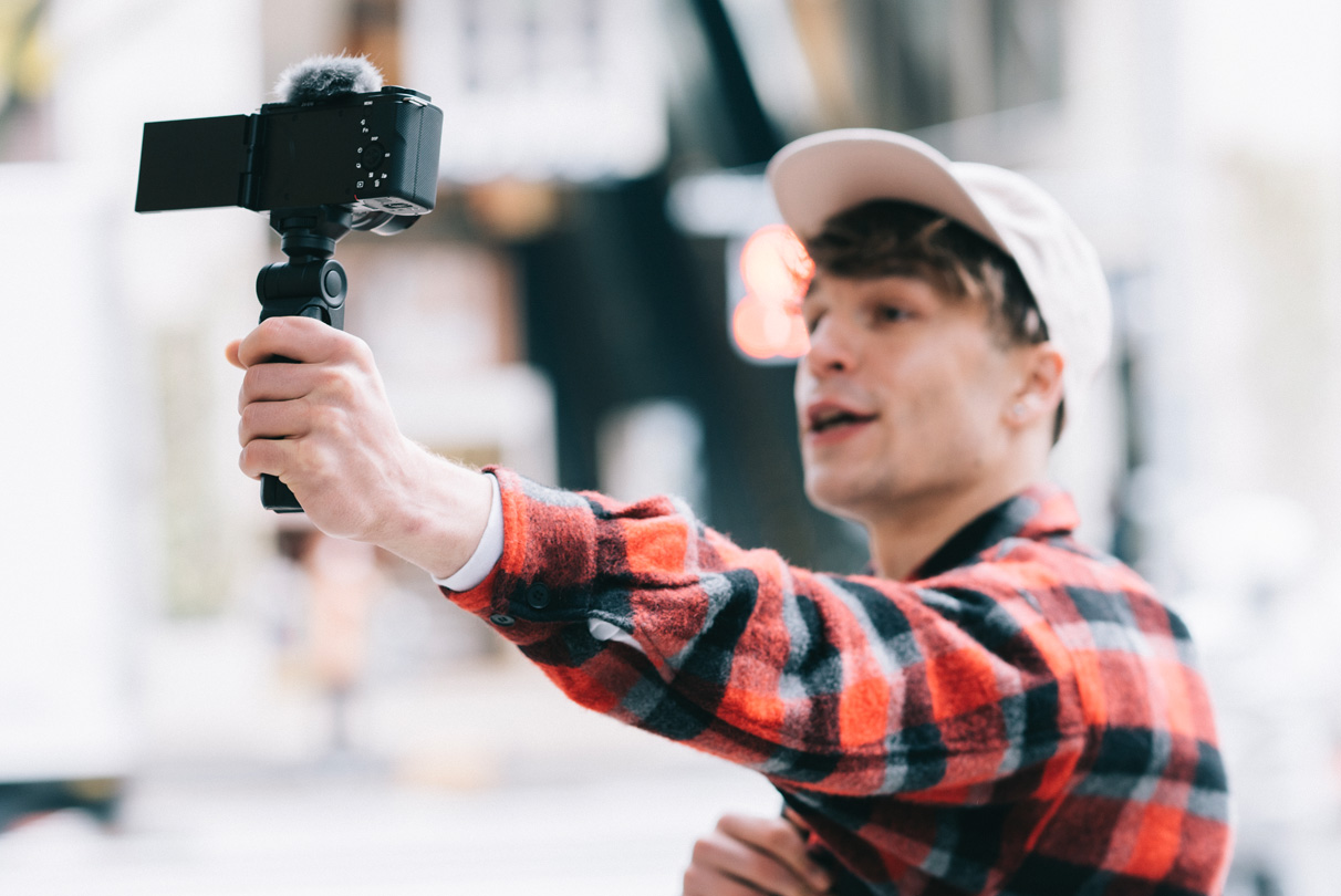 Situational image of a person recording video with the ZV-E10 while moving