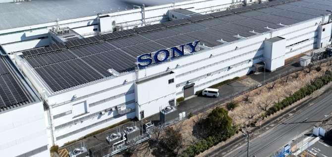 Shot of Sony manufacturing plant showing SONY logo and array of solar panels on the roof