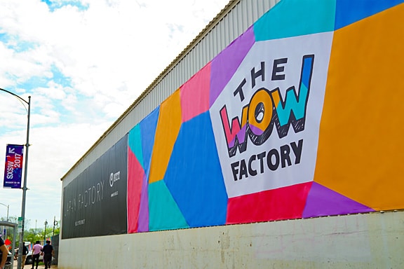 Photo of the WOW Factory logo displayed on the exterior wall of the venue.