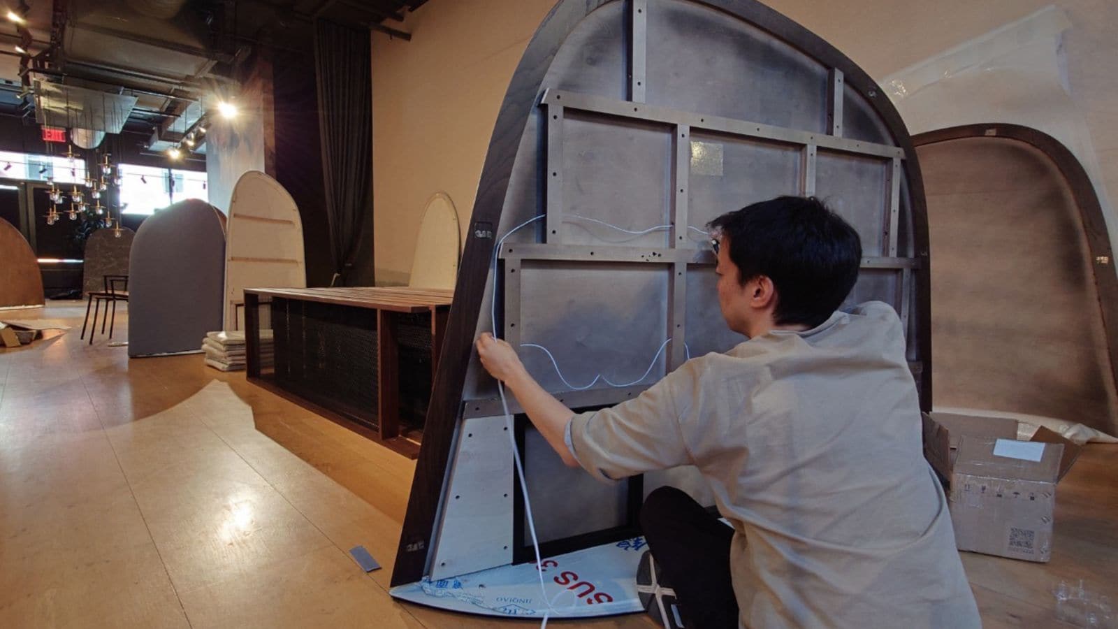 A person assembling internal components into ‘BYOBU’ partition