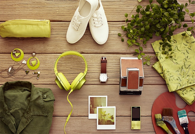 Image of h.ear over-ear headphones displayed with fashion items