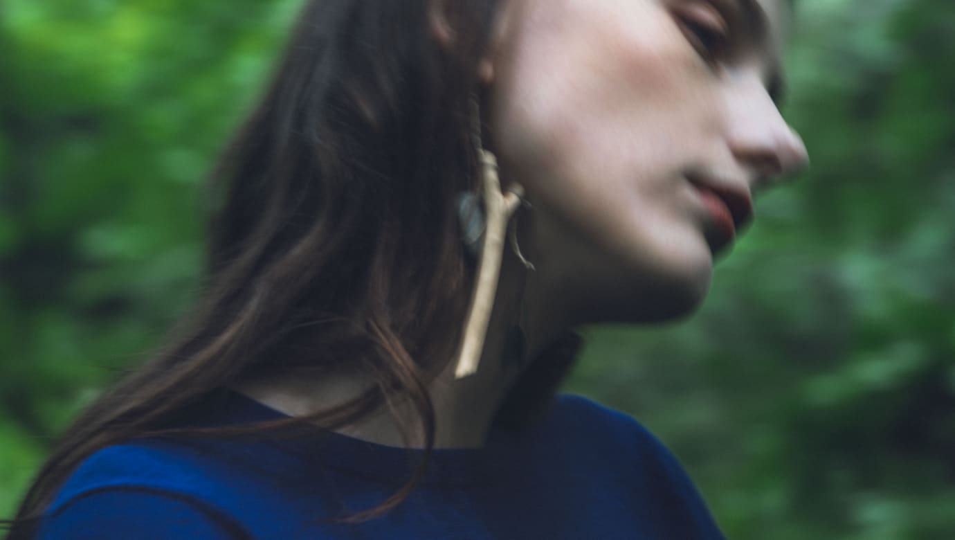 Photo of the wearable musical instrument attached to a woman's ear, swaying in the wind_2