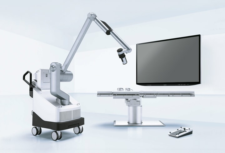 Image of an operating room equipped with the surgical microscope system and a large monitor