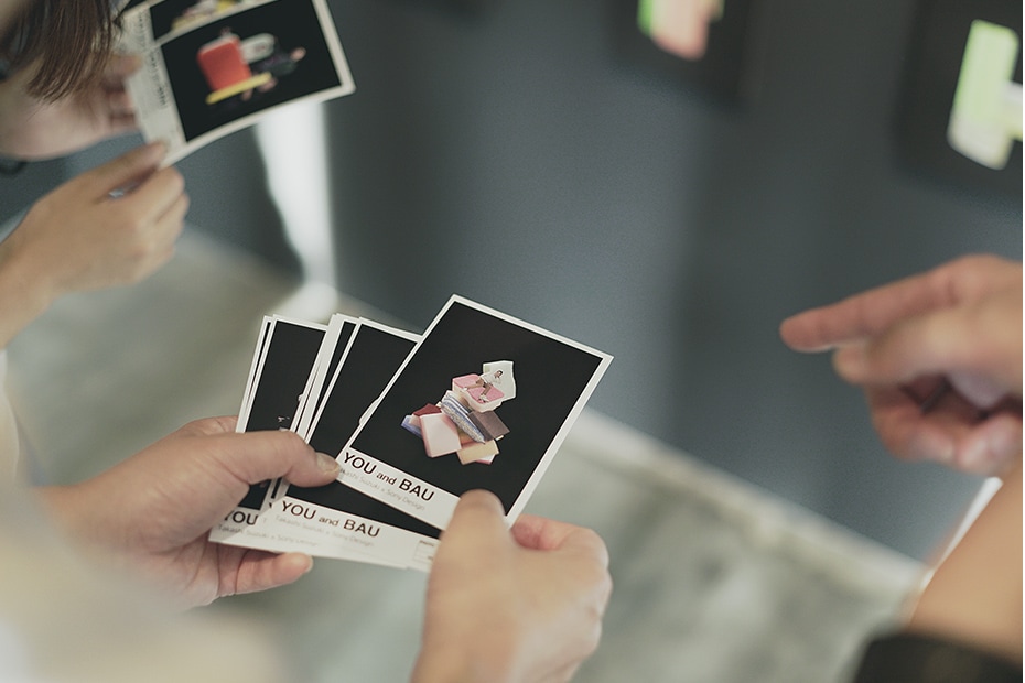 Photo of visitors holding actual prints of their own "YOU and BAU" creations