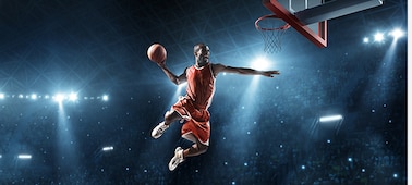 Image of a male basketball player trying to dunk shot.