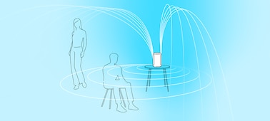 Illustration of two people in close proximity to a speaker emitting sound waves.