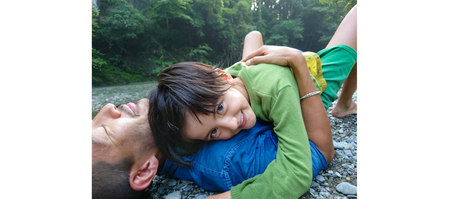 Image of father and daughter enjoying a barbecue by a river