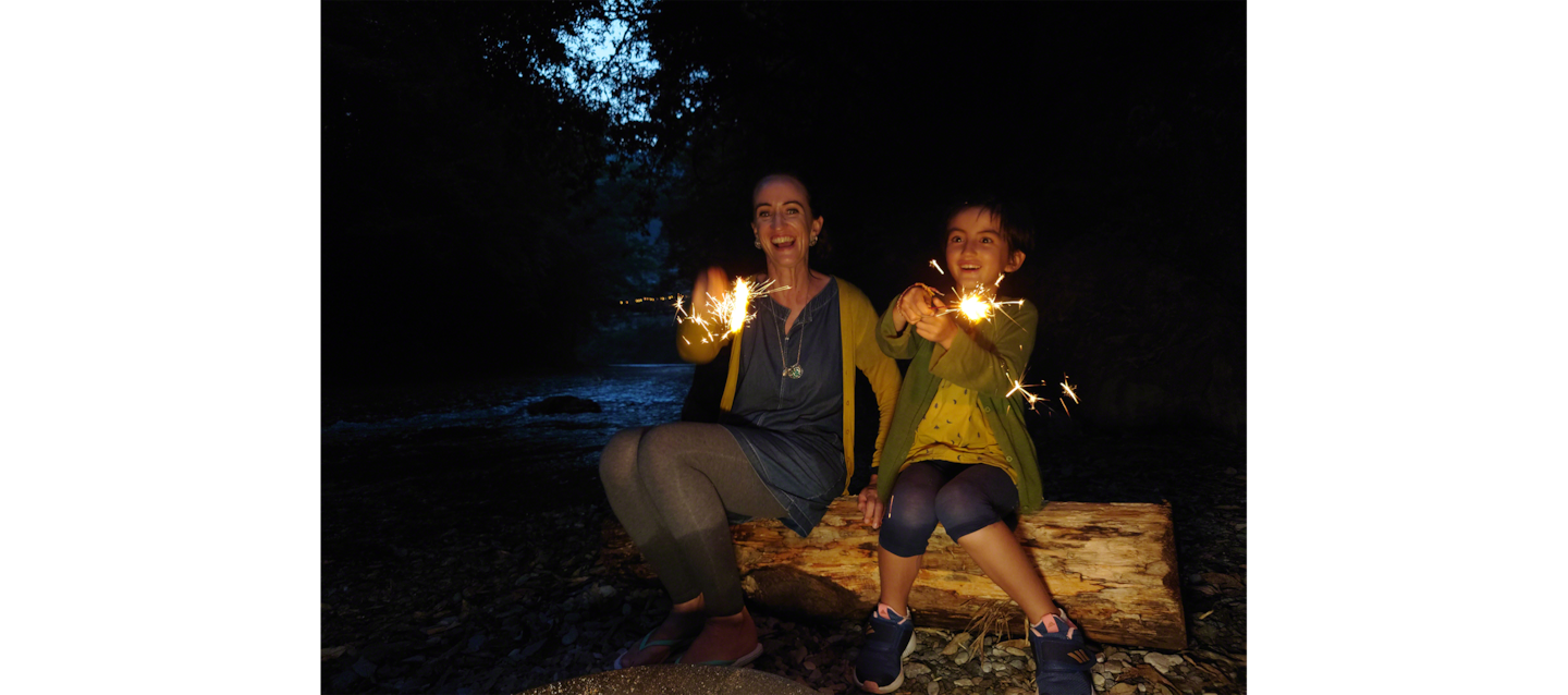 Image of father and daughter enjoying a barbecue by a river