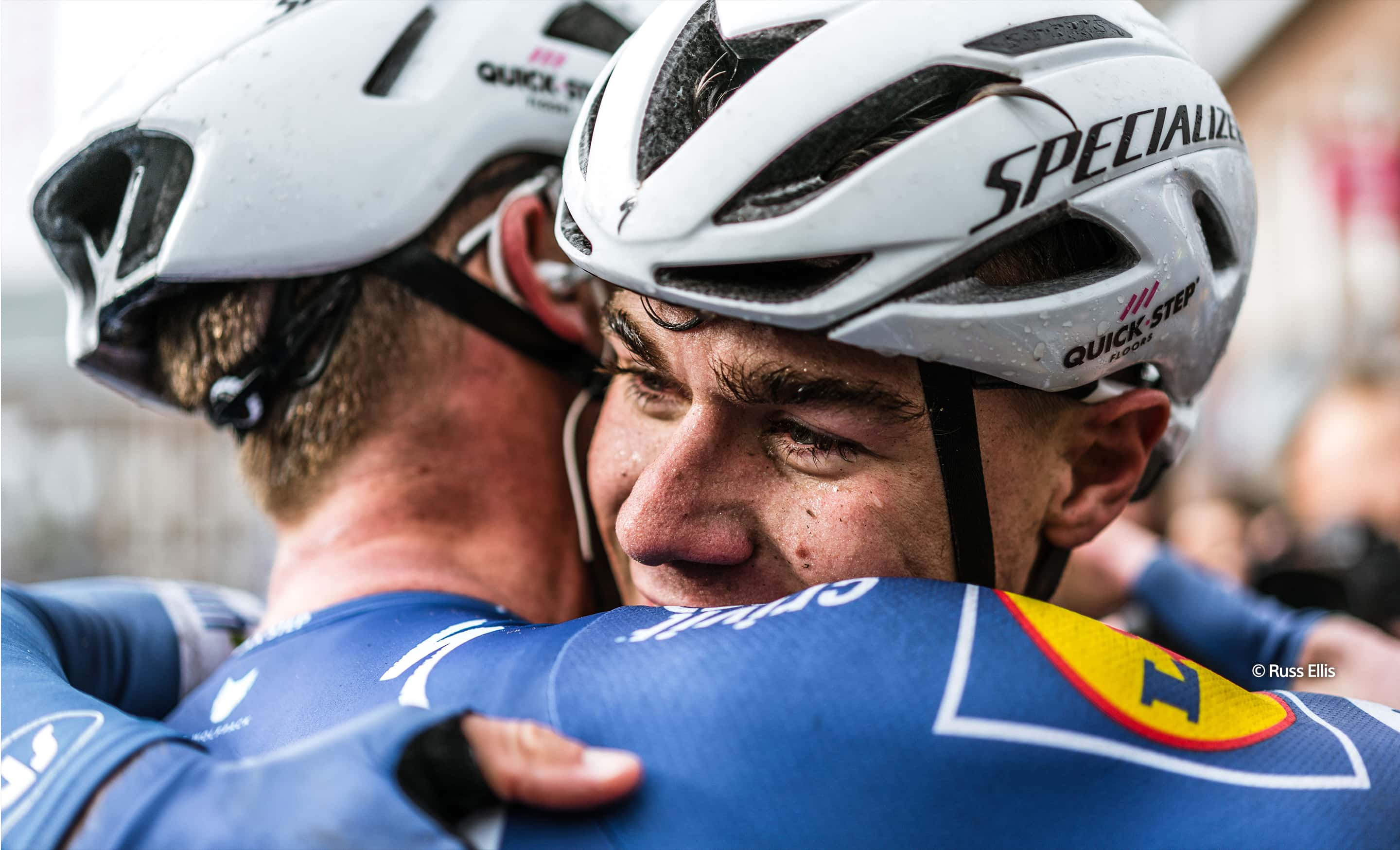 two men hugging in bike helmets