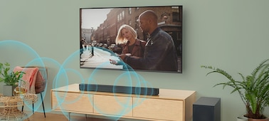 Blue sound waves emanating from a soundbar on a cabinet underneath a wall-mounted TV