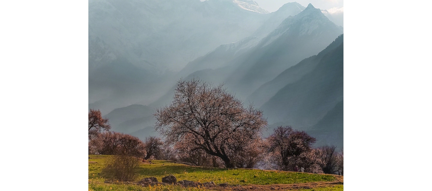 Image of father and daughter hugging by a river