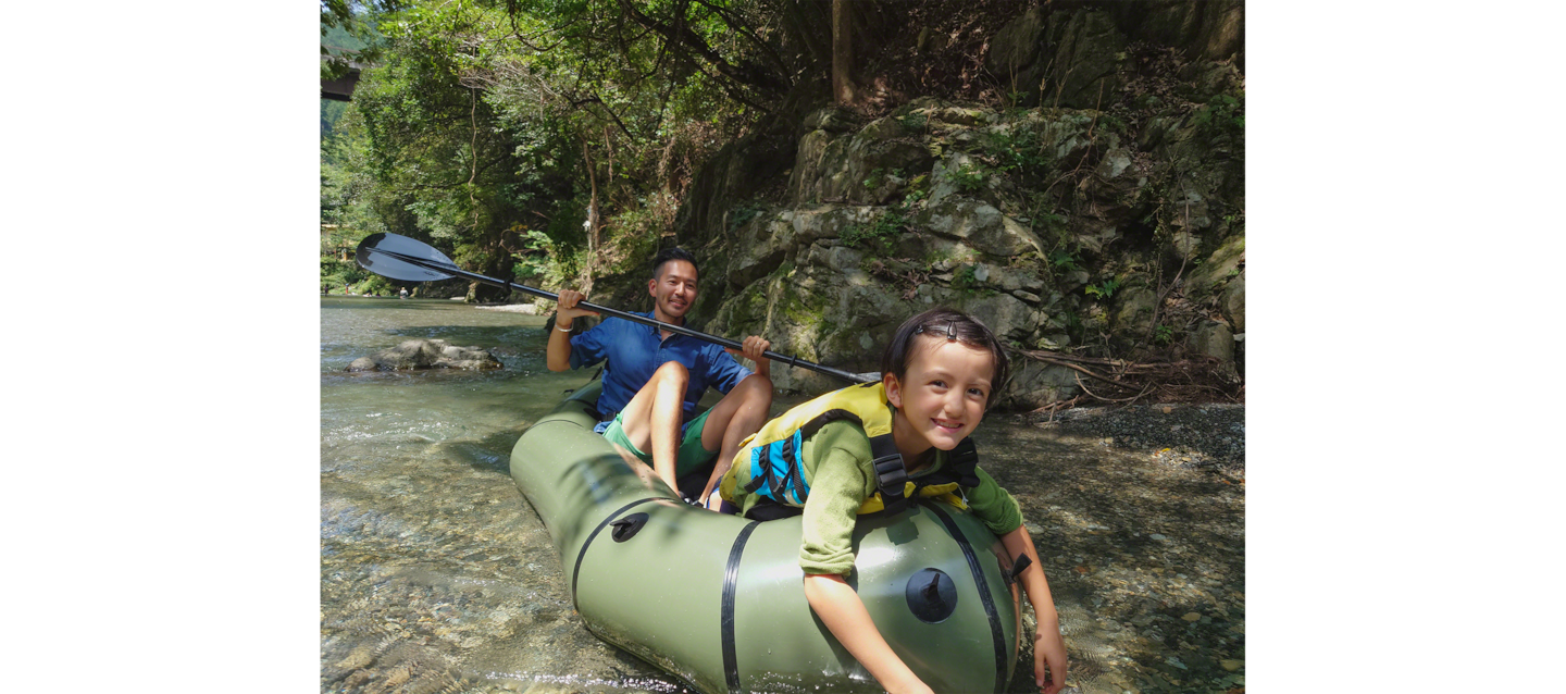 Image of father and daughter hugging by a river