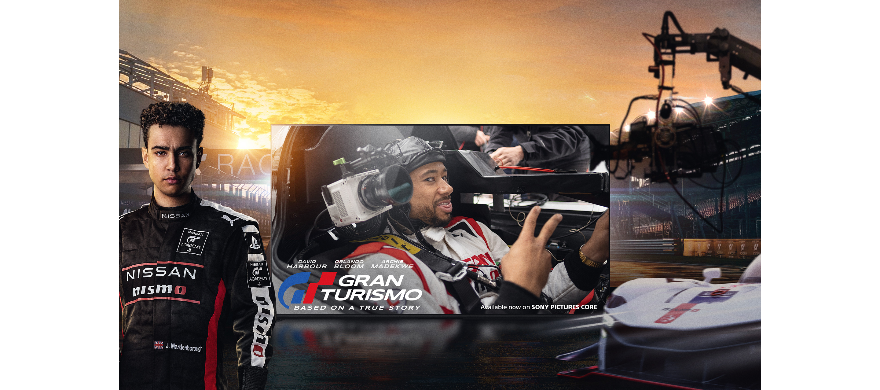 Front view of BRAVIA TV with screenshot of racing driver in a car and title "GRAN TURISMO Based on a true story" with racing driver standing to left and racing car with camera on a rig to right