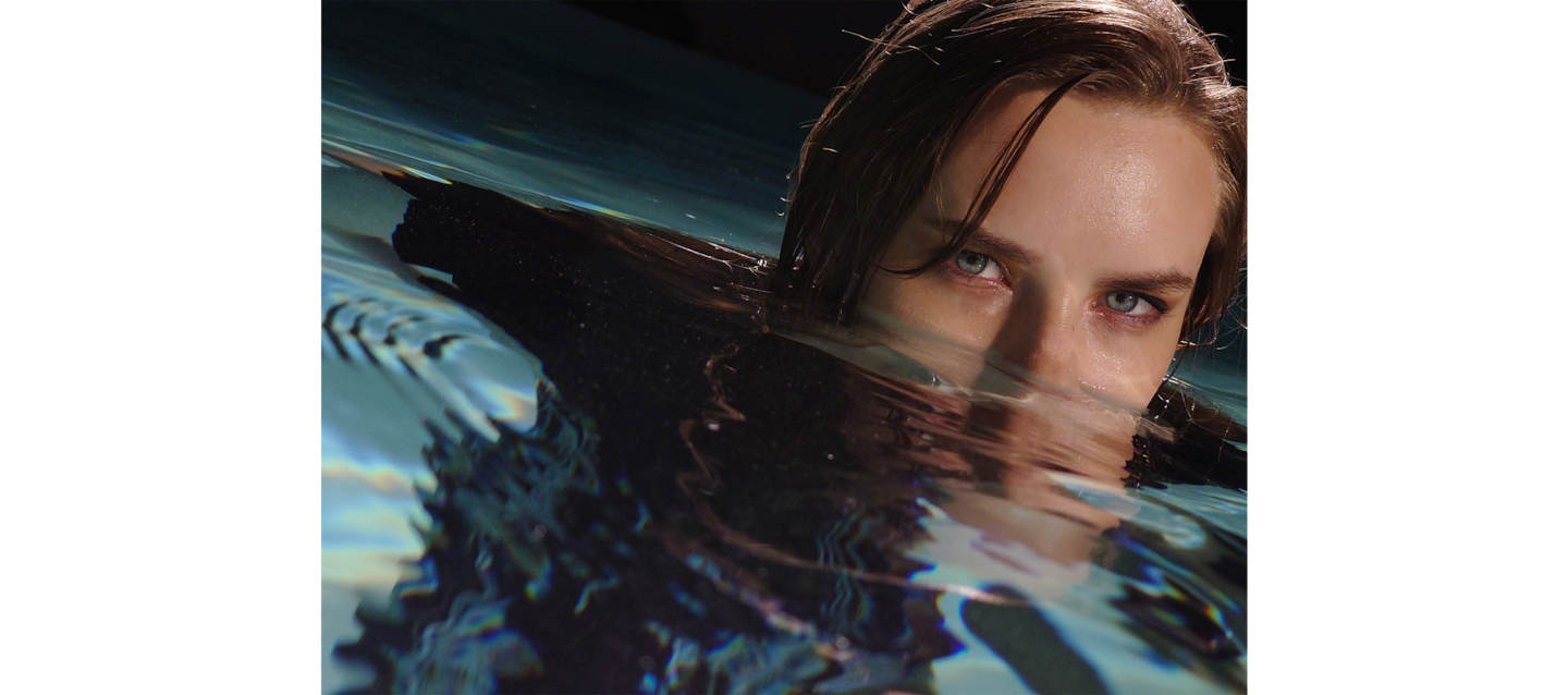 Image of little girl splashing water at the camera