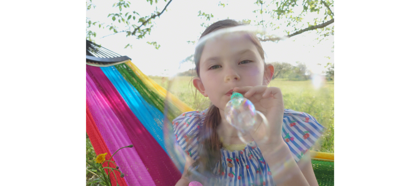 Image of little girl splashing water at the camera