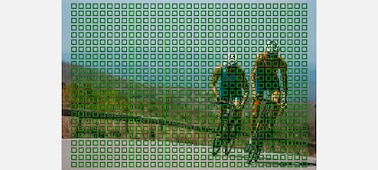 Example image of two cyclists racing uphill