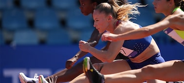 Example image showing three women jumping over the hurdle