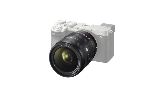 A product image showing the lens mounted on the desaturated α7C II